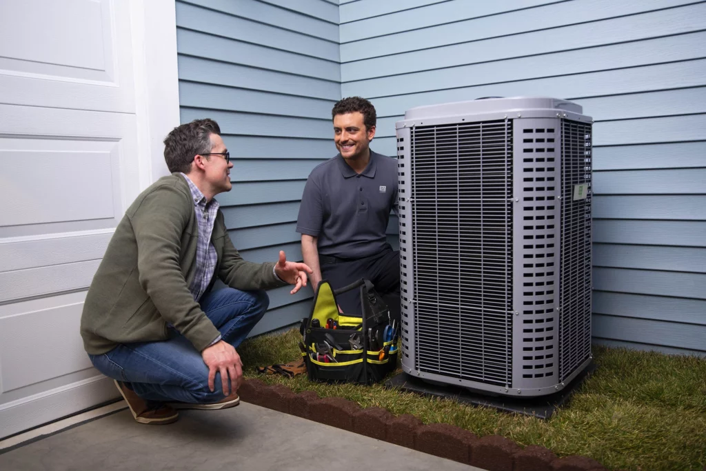 A professionals are fixing an air conditioner, demonstrating expertise in HVAC maintenance and repair.