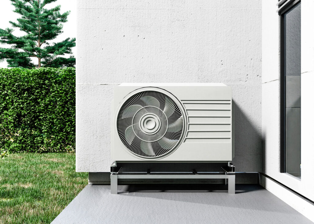 A air conditioner installed outside a house, providing cooling for the home during warm weather.