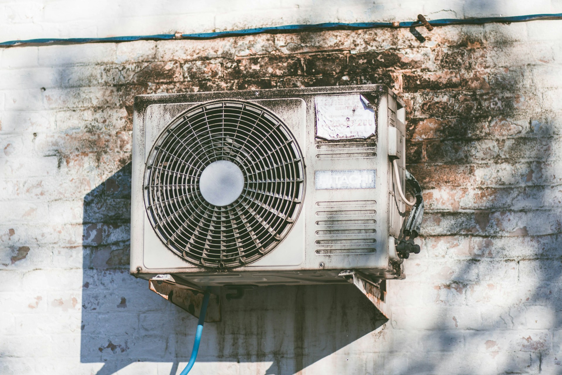 A air conditioner installed outside a house, providing cooling for the home during warm weather.